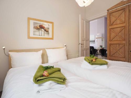 a white bed with two towels on top of it at Villa Lucie Else 06 in Heringsdorf
