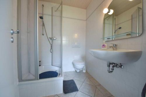a bathroom with a sink and a shower and a toilet at Bungalow Ostend in Ahlbeck
