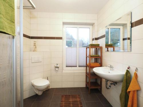 a bathroom with a toilet and a sink at Ferienhaus Sonneninsel 5c in Korswandt