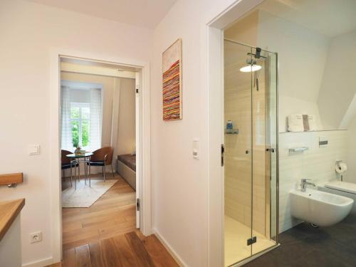 Un baño con ducha de cristal y lavabo. en Ferienhaus Kleines Palais, en Heringsdorf