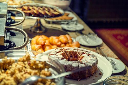 a table topped with plates of food and desserts at Spa Hotel Imperial in Karlovy Vary