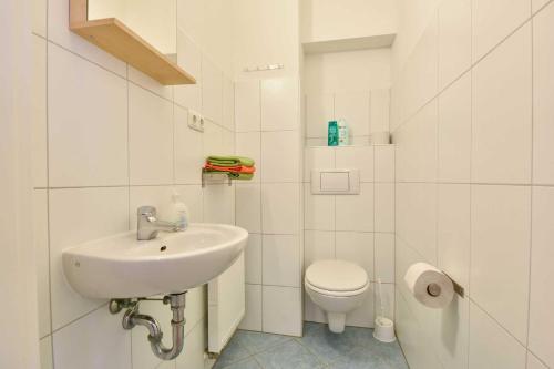 bagno bianco con lavandino e servizi igienici di Villa Lamora 02 a Heringsdorf