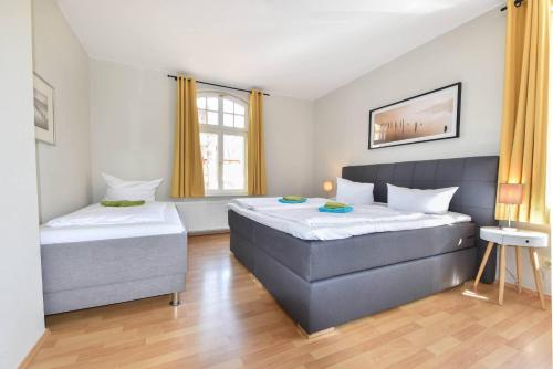 - une chambre avec 2 lits et une fenêtre dans l'établissement Haus Kogge Wohnung 1, à Heringsdorf
