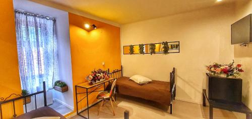 a small room with a bed and a television at Casa Crown in Braşov