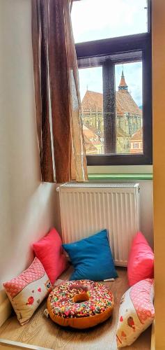 a room with colorful pillows and a donut on the floor at Casa Crown in Braşov