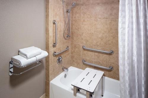 a bathroom with a shower and a white sink at Hyatt Place Austin Arboretum Domain Area in Austin
