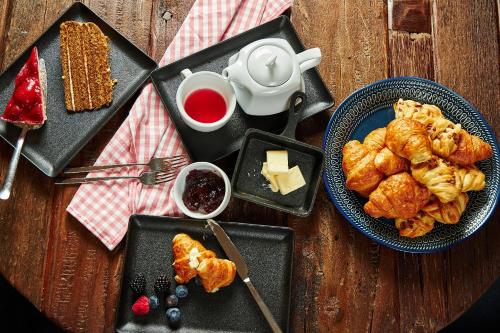 a table with a plate of food with pastries and butter at Penzion BERG in Bratislava