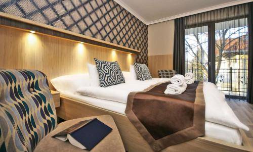 a suite on a boat with a bed and a window at Boutique Hotel Divina in Harkány