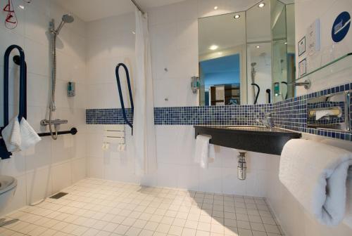 a bathroom with a sink and a mirror at Holiday Inn Express Hamilton, an IHG Hotel in Hamilton