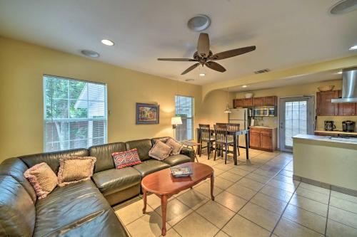 a living room with a leather couch and a kitchen at San Antonio House with Private Pool, Spa and Grill in San Antonio