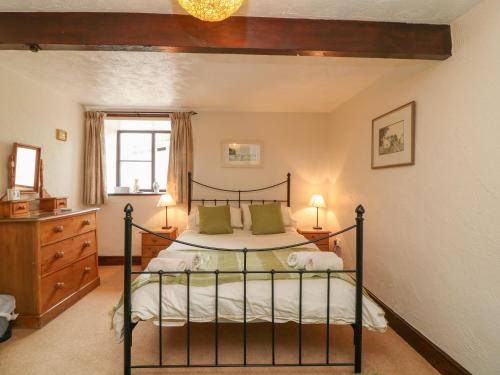 a bedroom with a bed and a dresser at The Cart Linhay in Westleigh
