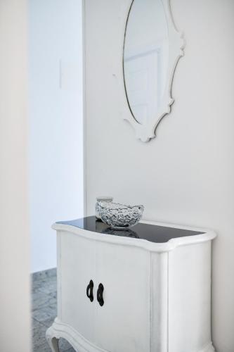 a white dresser with a mirror on top of it at Apartments Martom in Seline