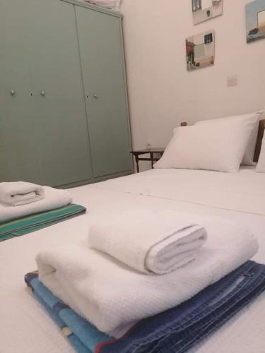 a pile of towels sitting on a bed at Matina's agora apartment with Terrace in Leonidion