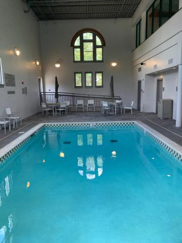 a swimming pool with blue water in a building at Country Inn & Suites by Radisson, St Charles Historic District in St. Charles