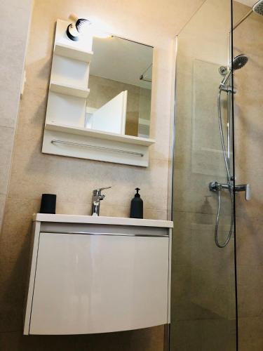 a bathroom with a sink and a mirror at Guest House Stipe in Brela