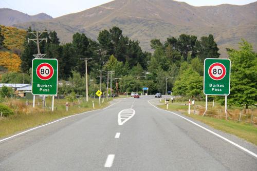 a road with two signs on the side of it at Burkes Pass Country Motels in Burkes Pass
