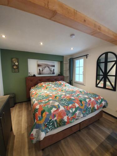 a bedroom with a bed with a colorful comforter at Das Herzchen von Cochem in Cochem