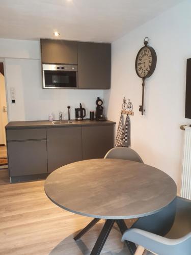 a kitchen with a wooden table and a dining room at Das Herzchen von Cochem in Cochem
