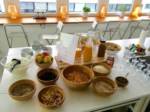 a table with many bowls of food on it at Business Hotel Wiesbaden PRIME in Wiesbaden