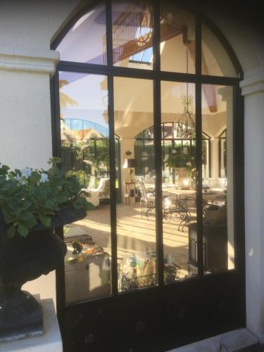 a view of a patio through a large glass door at Les Prémices De La Forêt in Chailly-en-Bière