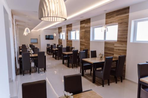 a dining room with tables and chairs at Princ Apartment in Niš