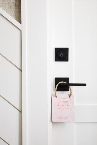 a bag on a door with a do not disturb sign at The Edgartown Inn, The Edgartown Collection in Edgartown