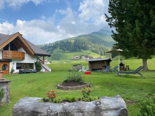 a person sitting on a bench in a yard at Chalet Romy AP 3 in Pramauron