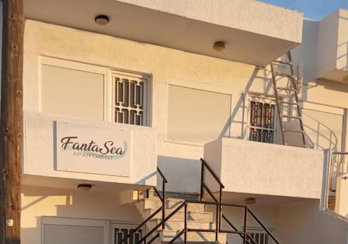 a building with a sign on the side of it at FantaSea Apartments in Haraki