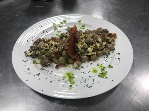 a white plate of food on a table at LA CASONA DE PALMIRA in Caín
