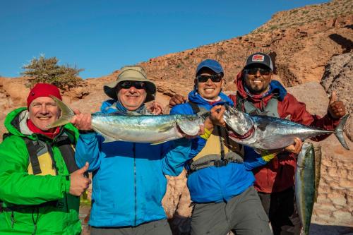 a group of people holding up a fish at Hotel Posada Luna Sol in La Paz