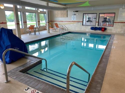 a large swimming pool with blue water in a building at Holiday Inn Express Moline - Quad Cities Area, an IHG Hotel in Moline