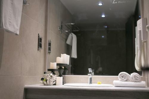 a bathroom with a sink and a mirror at La Piscine Art Hotel, Philian Hotels and Resorts in Skiathos Town