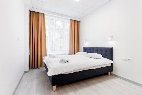 a bedroom with a large bed in front of a window at Apartments Daina in Jūrmala