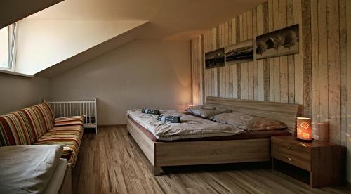 a bedroom with a bed and a couch at Nina Liptov in Liptovský Ján