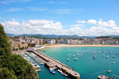 a group of boats docked at a dock in a harbor at Pensión Régil in Donostia-San Sebastián