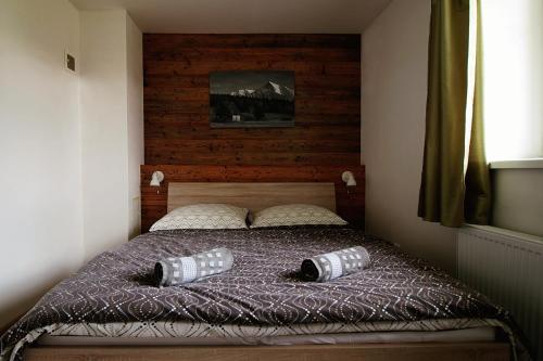 a bedroom with a bed with two pillows on it at Nina Liptov in Liptovský Ján
