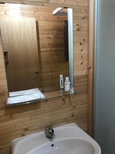 a bathroom with a sink and a mirror at Glamorous Cabin on a Farm in Vila do Bispo