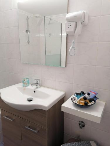 a bathroom with a sink and a mirror at Nini's House 1 Nydri - 100m from beach NYDRI TOWN CENTER in Nydri