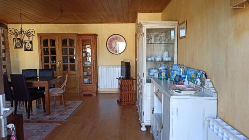 a kitchen with a table and a dining room at Casa Santiago in Currelos