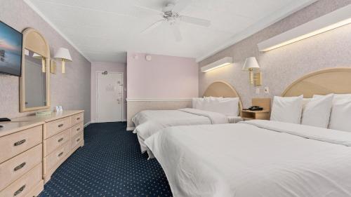 a hotel room with two beds and a mirror at Adventurer Oceanfront Inn in Wildwood Crest