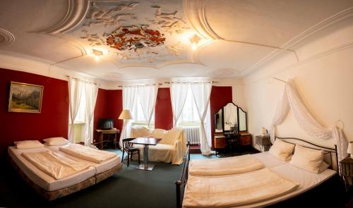 a bedroom with two beds and a ceiling at Gästehaus am weißen Turm in Rothenburg ob der Tauber