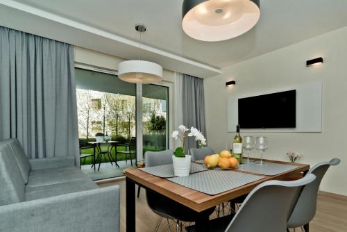 a living room with a dining table and a couch at BlueApart Apartamenty Na Klifie in Władysławowo