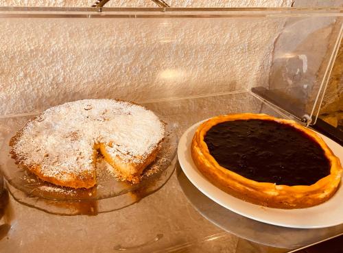 two pieces of pie sitting on a table with a plate at L’Oca Giuliva Relais in Gaggio Montano