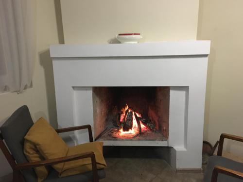 a fireplace in a living room with a fire at Martv'Elle Boutique Guesthouse in Martvili