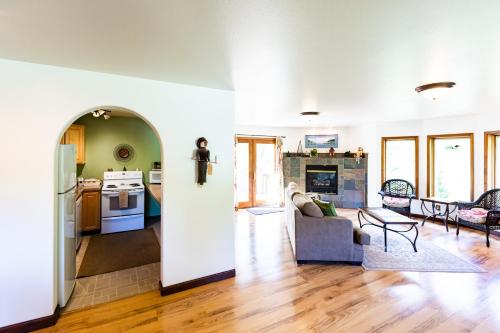 a kitchen and a living room with a couch and a table at Inn at Tern Lake in Moose Pass