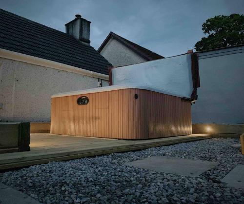 a building with a door on the side of a house at Highland HotTub Retreat, on NC500 in Inverness