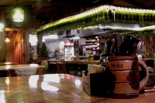 a cup of utensils sitting on a table in a restaurant at Hotel Mitos in Quellón