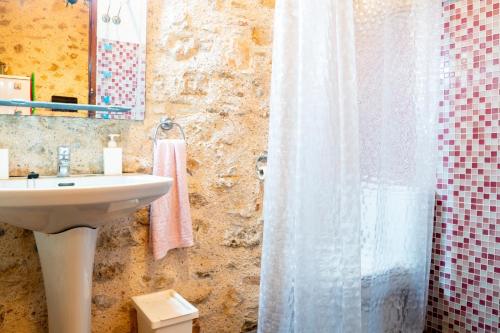 a bathroom with a sink and a shower curtain at Casa Boutique Margarita in Peniscola