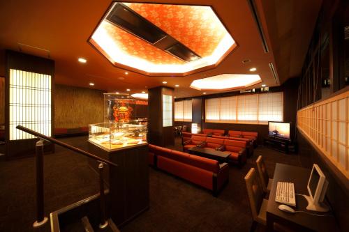 a lobby with a waiting room with couches and a television at Matsui-Bekkan Hanakanzashi in Kyoto