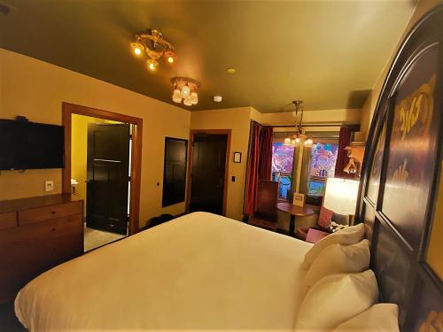 a bedroom with a large white bed and a tv at McMenamins Elks Temple in Tacoma